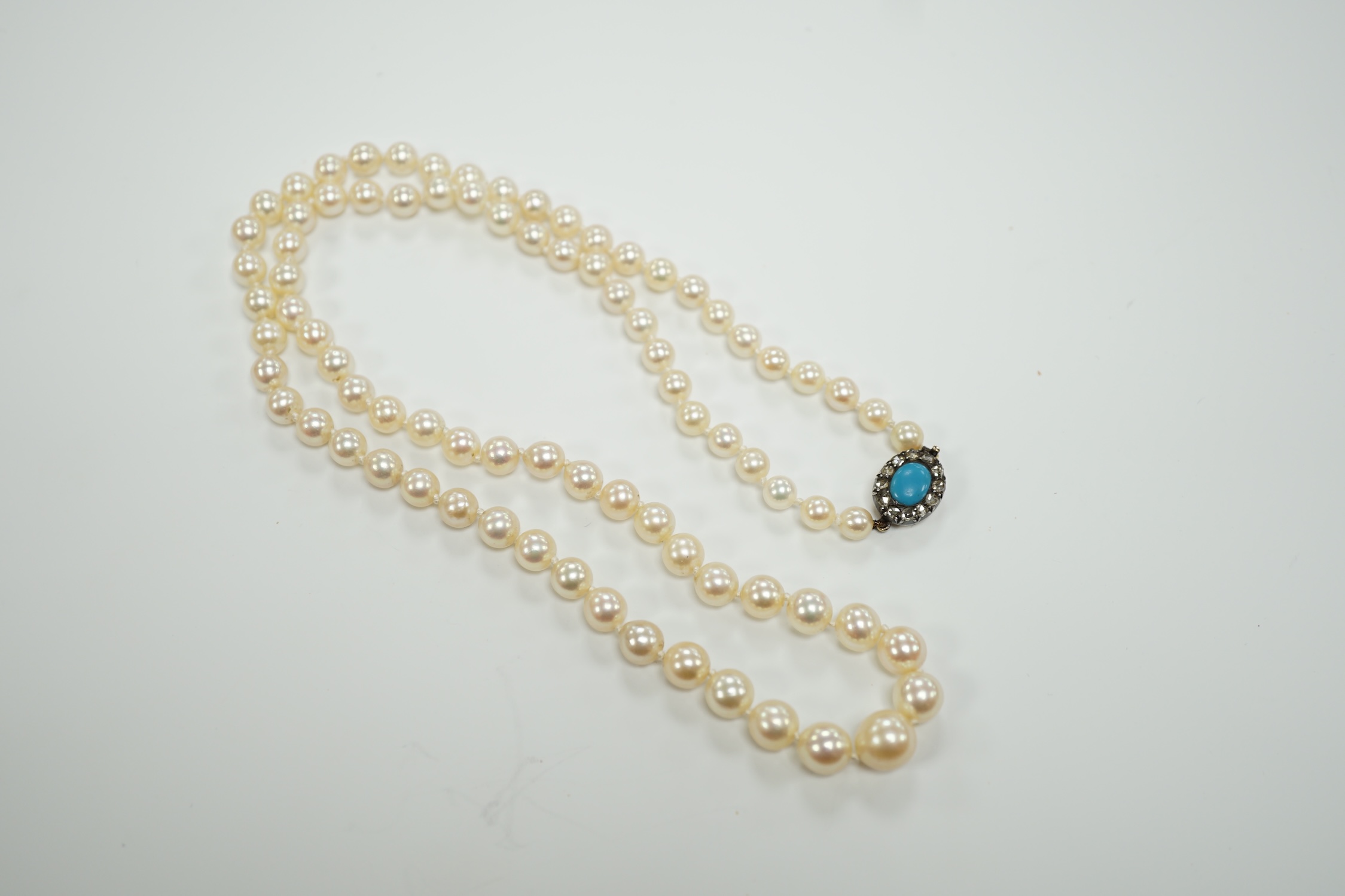 A single strand graduated cultured pearl necklace, with turquoise and diamond set yellow metal clasp, 58cm.